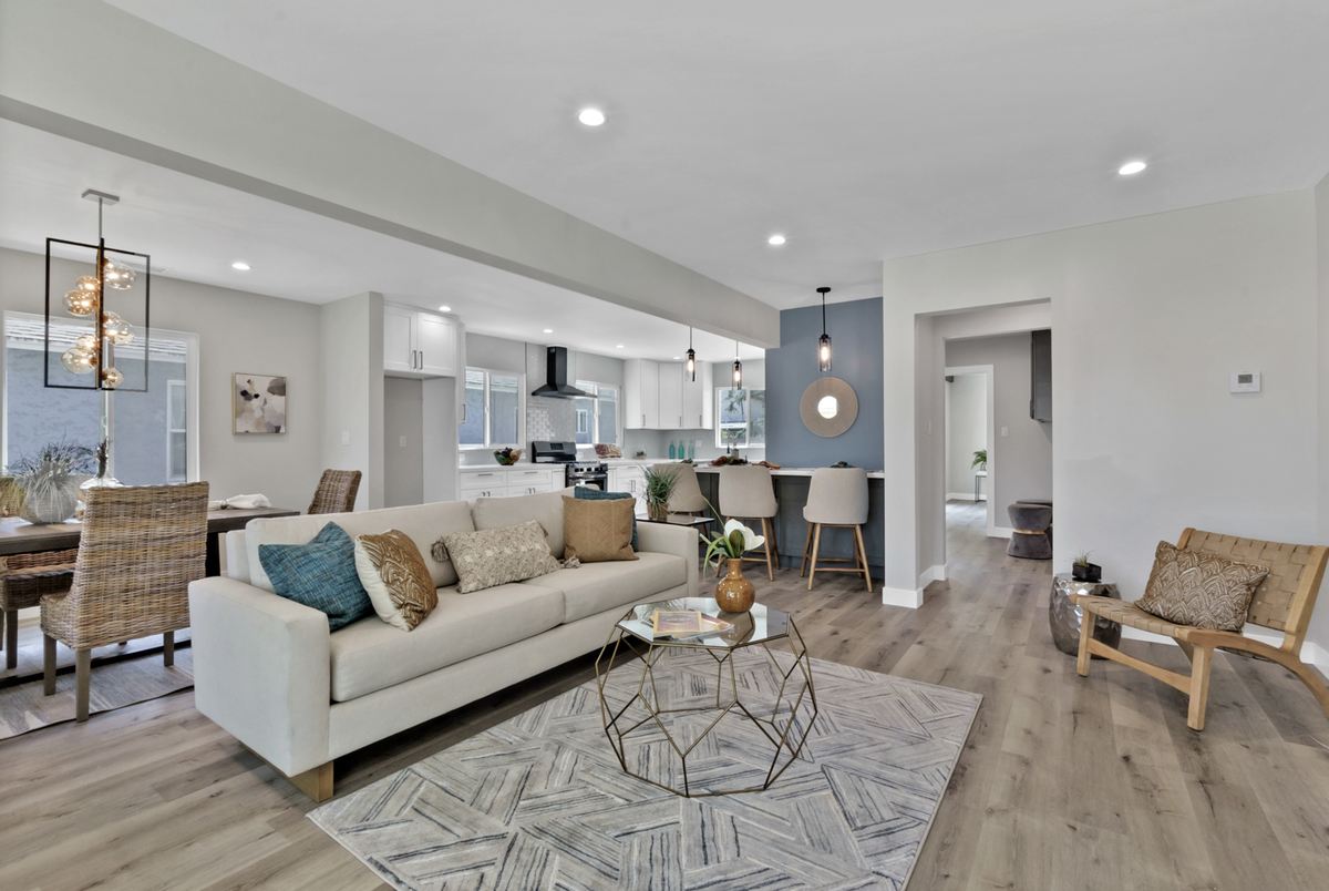 The same house after renovation: open-plan living and kitchen, staged and finished